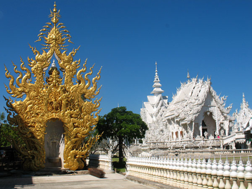 Wat Rong Khun, perhaps better known to foreigners as the White Temple, is a privately owned art exhibit in the style of a Buddhist temple in Chiang Rai Province, Thailand. It is owned by Chalermchai Kositpipat, who designed, constructed, and opened it to visitors in 1997.