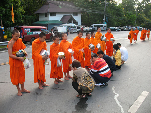 Thai people offering monks food in Chiang Mai