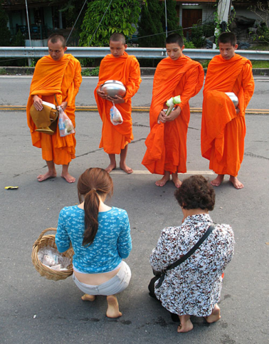 Women offering monks food in Chiang Mai
