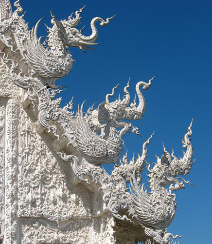Detail of Wat Rong Khun, perhaps better known to foreigners as the White Temple, is a privately owned art exhibit in the style of a Buddhist temple in Chiang Rai Province, Thailand. It is owned by Chalermchai Kositpipat, who designed, constructed, and opened it to visitors in 1997.