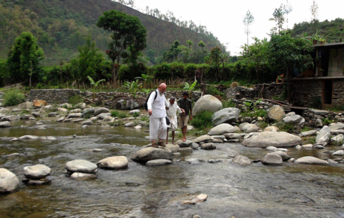 Ganga helping Father Varma across the stream