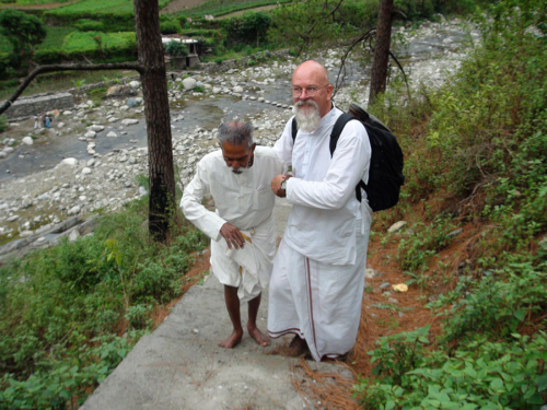 Ganga helping Father Varma up the stairs