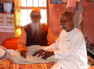 Father Varma receiving blessing of Paramananda Puri Maharaj