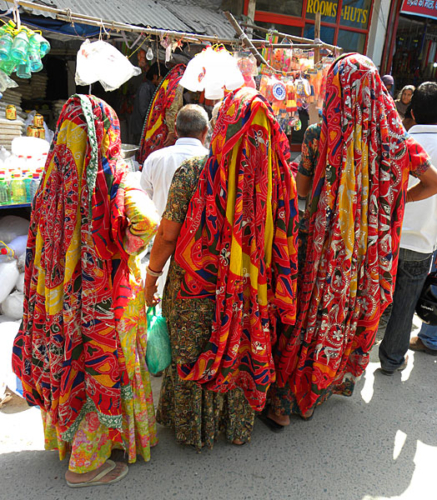 Colorfully dressed women shopping.