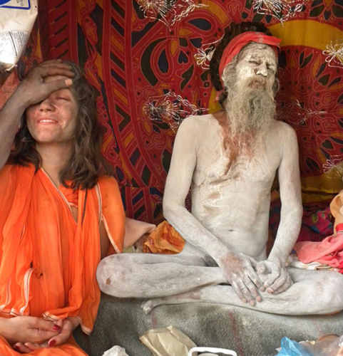 Western woman getting shaktipat next to naga baba